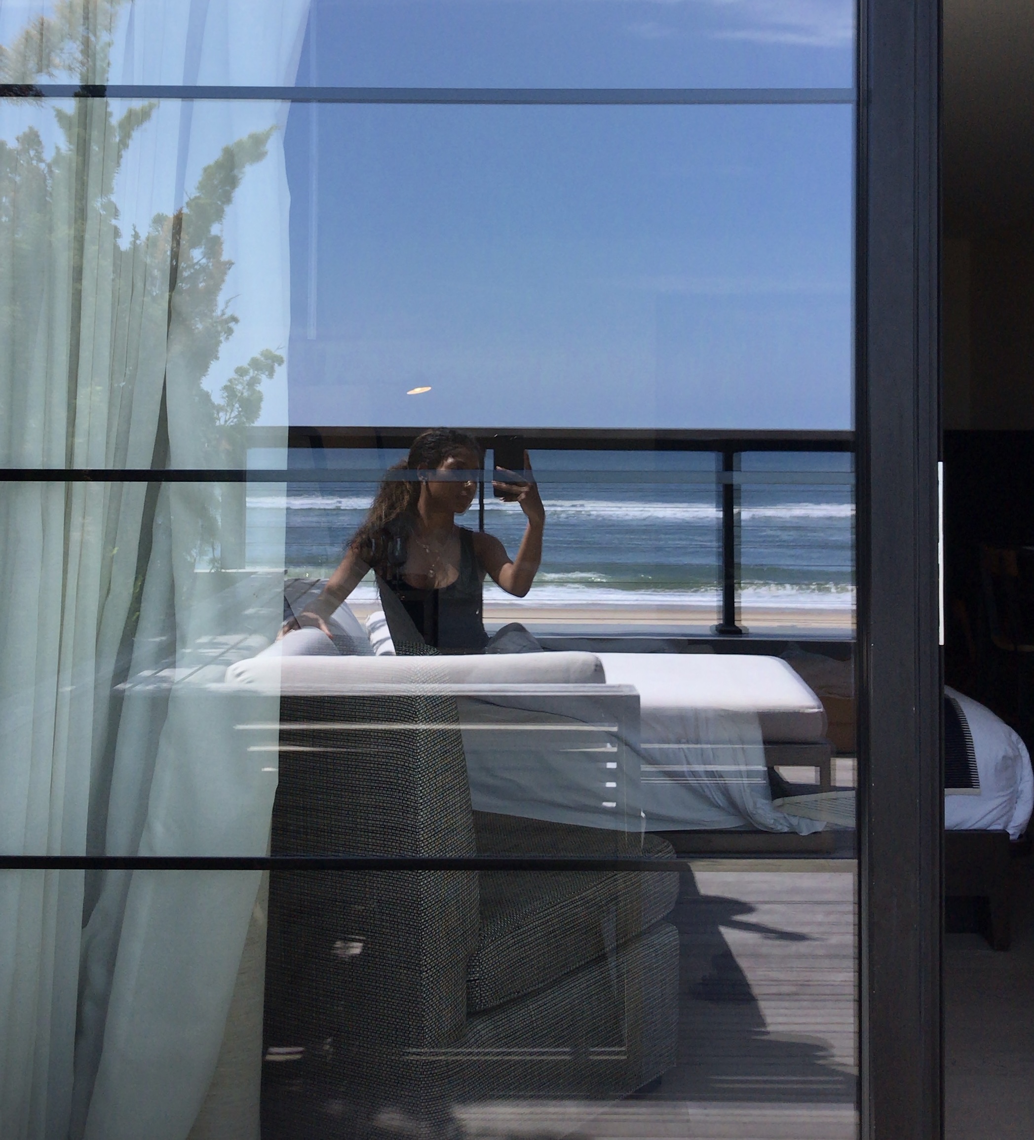 Glass-walled room overlooking the ocean
